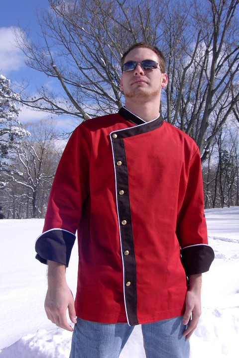 Chef Coat Style BSM105: Shown in Red & Black 100% cotton gabardine, with Snow White piping, left sleeve tailored welt pocket, & brass buttons.