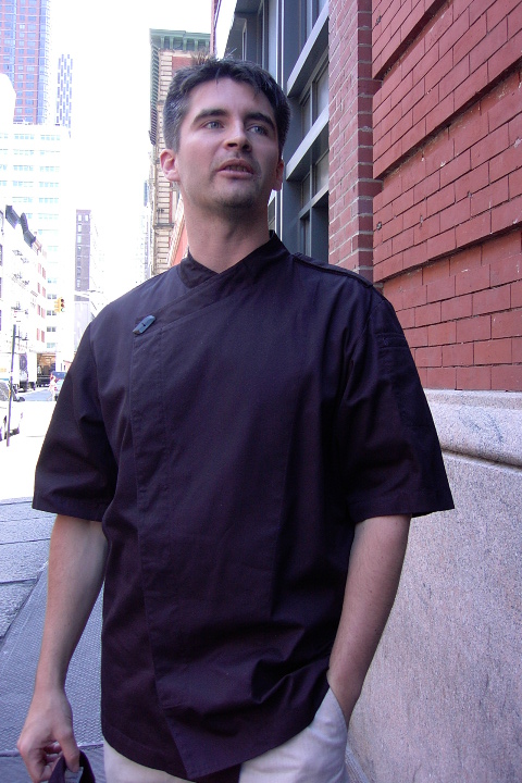 Chef Coat Style BSM105H: Shown in black, 100% cotton gabardine, short sleeves, left shoulder epaulette & one horn button.