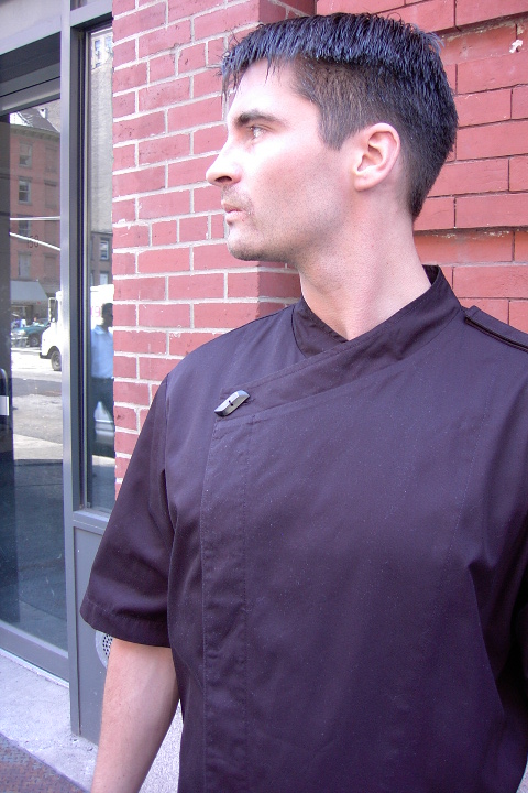 Chef Coat Style BSM105H: Shown in black, 100% cotton gabardine, short sleeves, left shoulder epaulette & one horn button.