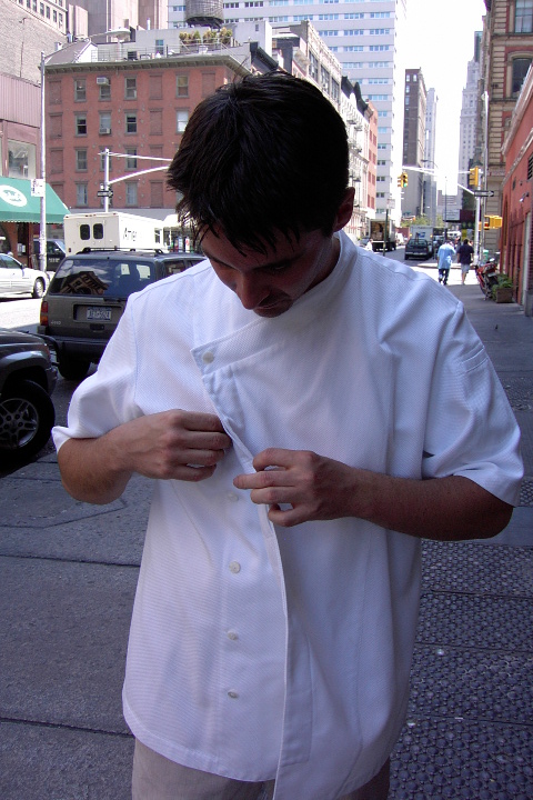 Chef Coat Style BSM105H: Shown in white, 100% cotton Gabardine, short sleeves, left sleeve tailored welt pocket & one faux mother-of-pearl button.