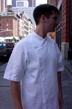 Chef Coat Style BSM105H: Shown in white, 100% cotton Gabardine, short sleeves, left sleeve tailored welt pocket & one faux mother-of-pearl button.