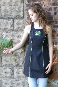 Women's Bib apron style W740; Shown in black, 100% cotton Ripstop with Lime piping along princess seams, & embroidered Lime Botanical on center chest.
