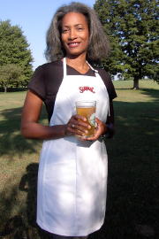 Women's Bib apron style W740; Shown in white, 100% cotton gabardine with two side hip, on seam pockets & embroidered Saranac logo on center chest.