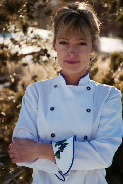 Women's Chef Coat Style BSW100: Shown in White, 100% cotton petti point pique, Blue suede piping (collar & cuffs), Blue mussel buttons, Left sleeve tailored welt pocket & blueberry wreath embroidery (one on each cuff, $15 each).