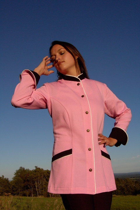 Women's Chef Coat Style BSW103: Shown in pink & black, 100% cotton petti point pique, ivory piping (collar, front, cuffs & pockets) two front hip tailored welt pockets, & metal on black horn horse head buttons.