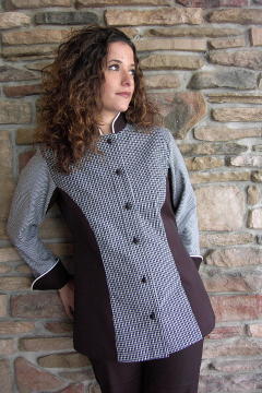 Women's Chef Coat Style CBW104: Shown in white & black plaids & checks & black cuffs, collar & side panels, 100% cotton Supima® Gabardine, snow white piping (collar & cuffs) & hand tied knot buttons.