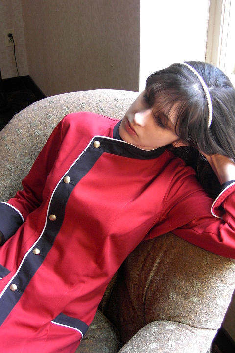 Women's Chef Coat Style BSW105: Shown in Red & Black 100% cotton gabardine, with Snow White piping, two front-hip tailored welt pockets, & brass buttons.