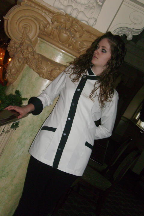 Women's Chef Coat Style BSW105: Shown in White & Black, 100% cotton gabardine, with Snow White piping, two front-hip tailored welt pockets, & faux mother-of-pearl buttons.