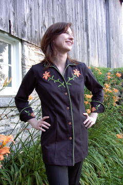 Women's Chef Coat Style BSW109: Shown in Black, 100% cotton gabardine, Meadow piping (collar, cuffs and front), Awabi buttons & Tiger Lilly embroidery (chest, cuffs & back).